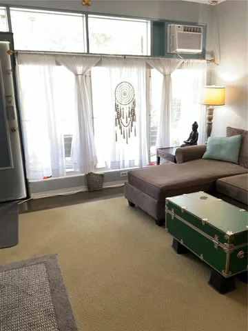 a living room with a bed furniture and a window