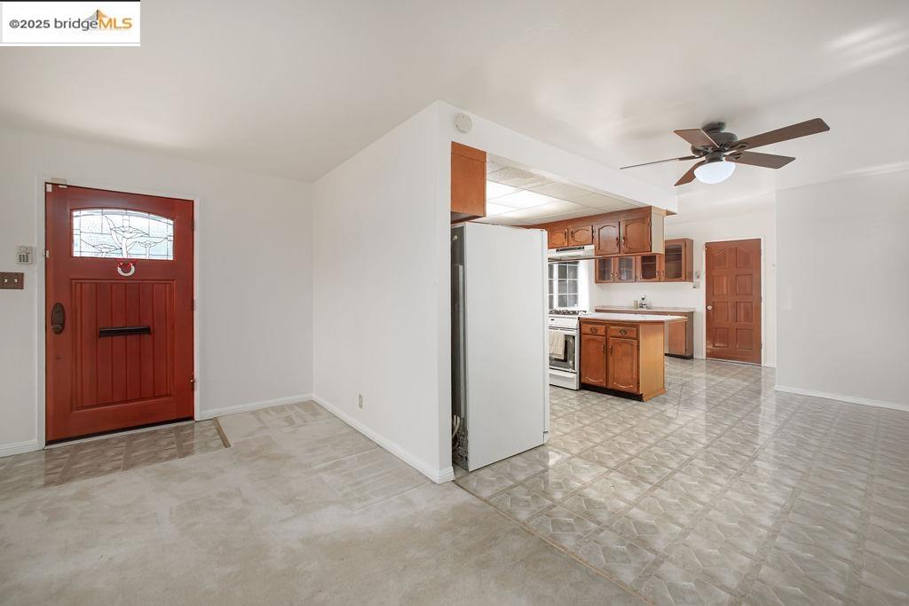 1651 Michael Drive Pinole, CA 94564 - Photo 5 of 21 a view of a kitchen with a stove cabinets a ceiling fan and wooden floor