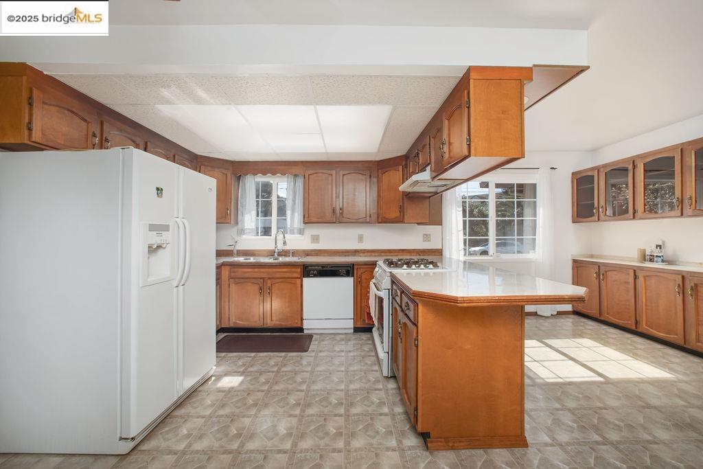 1651 Michael Drive Pinole, CA 94564 - Photo 6 of 21 a kitchen with stainless steel appliances granite countertop a stove and a refrigerator