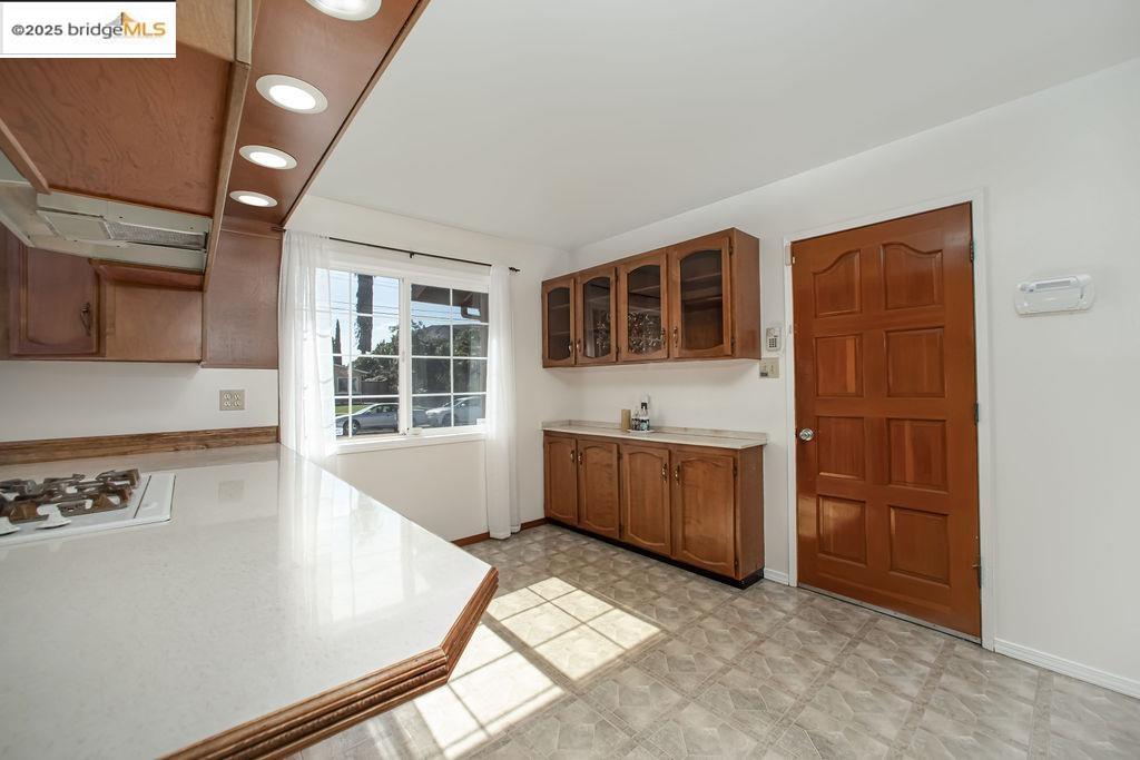 1651 Michael Drive Pinole, CA 94564 - Photo 7 of 21 a view of a kitchen with a sink dishwasher and wooden cabinets