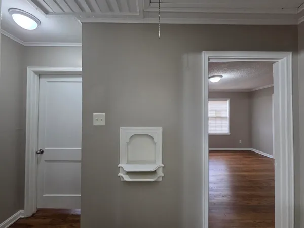 a view of a closet area with wooden floor