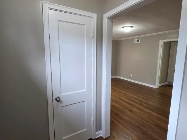 a view of a hallway with wooden floor