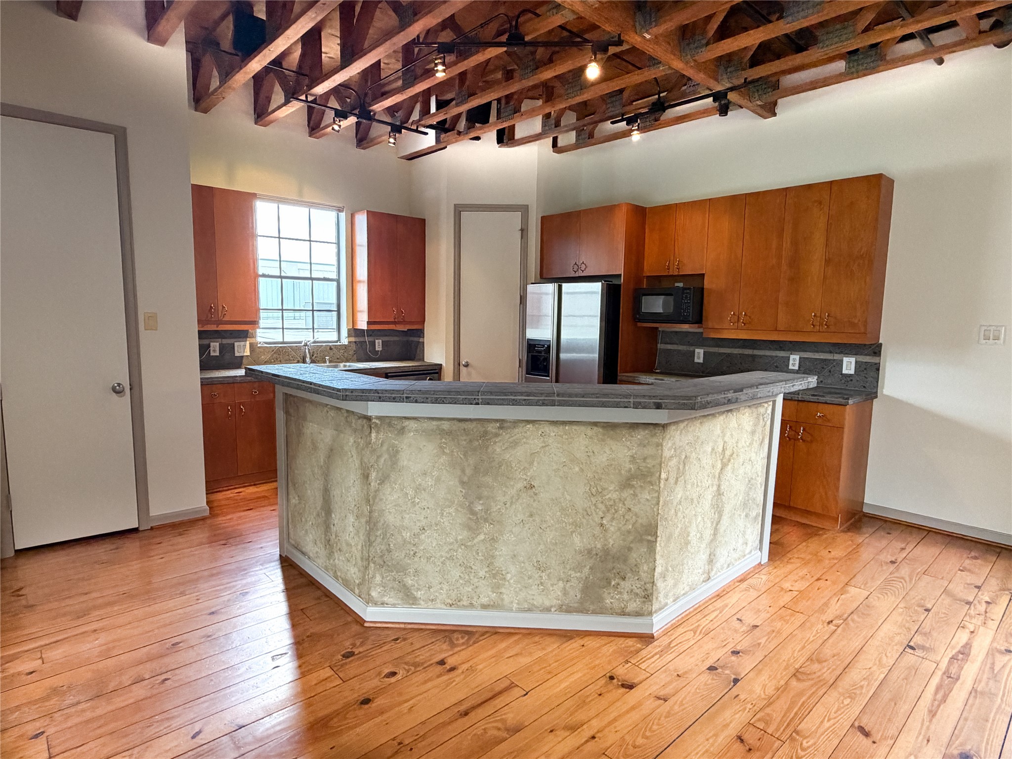 1213 Dunlavy Street Houston, TX 77019 - Photo 14 of 27 a kitchen with kitchen island granite countertop a sink a counter space and stainless steel appliances