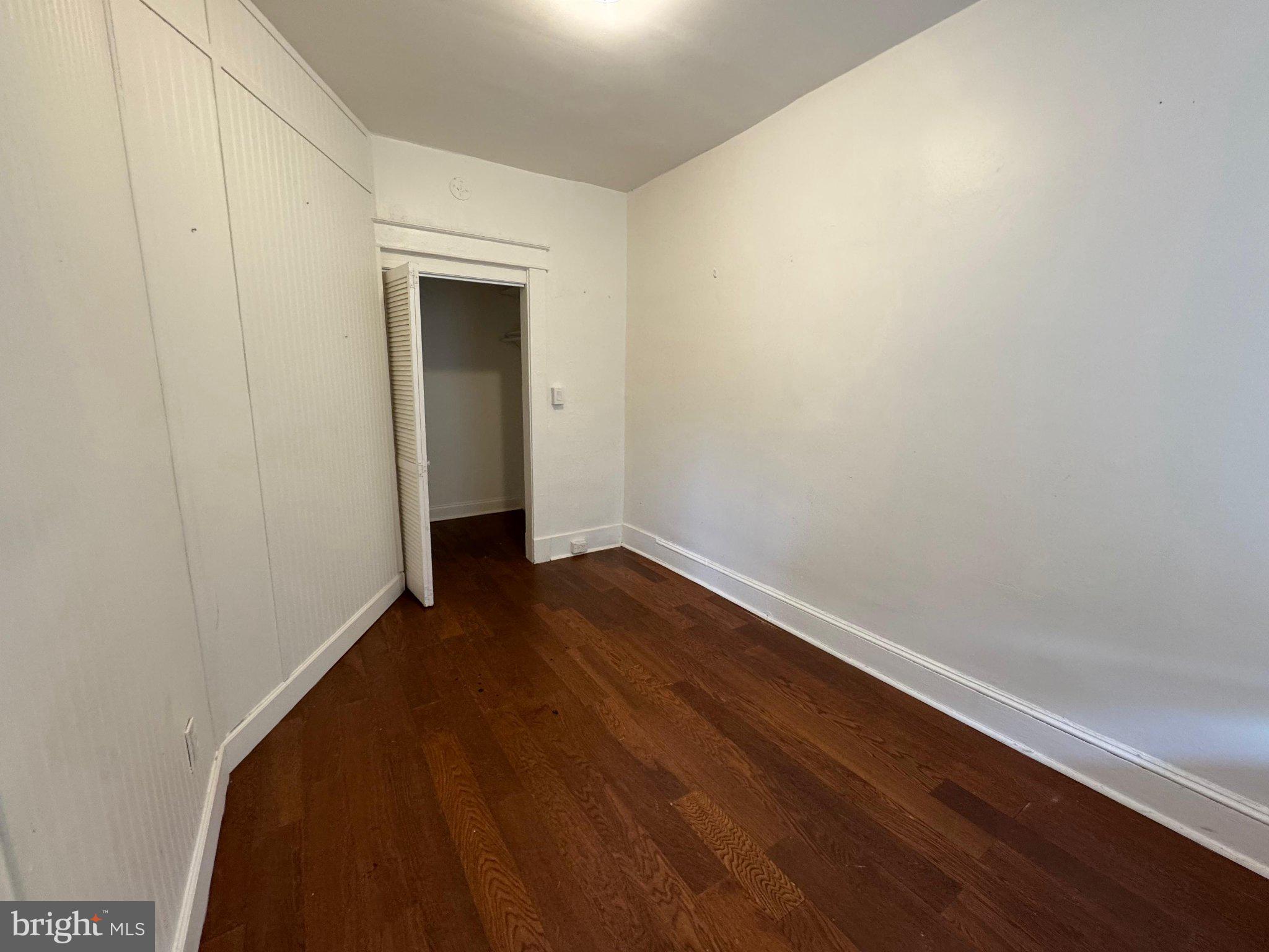 707 Denison Street Baltimore, MD 21229 - Photo 3 of 18 Spacious room with warm wood floors.