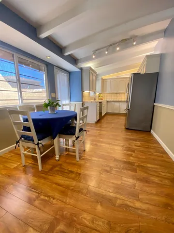a workspace with wooden floor and furniture