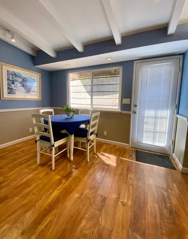 a view of a room with wooden floor
