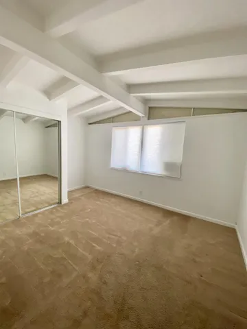 a view of an empty room and a window