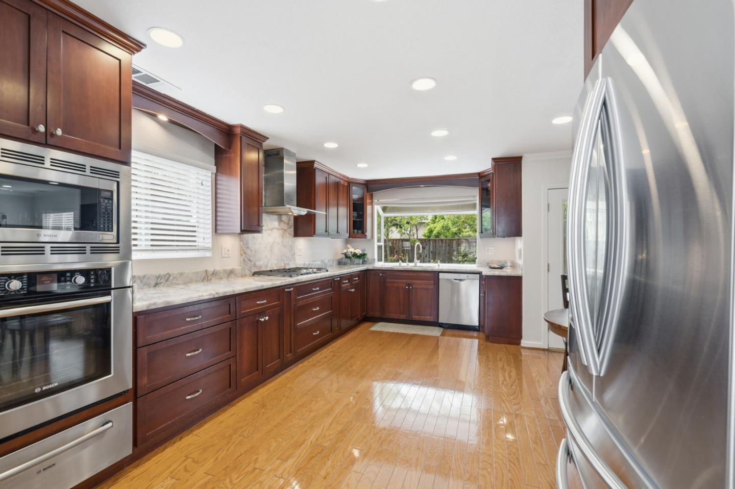 35 Sierra Ridge Court Danville, CA 94506 - Photo 8 of 37 a large kitchen with stainless steel appliances granite countertop a refrigerator a stove and a sink with wooden floor