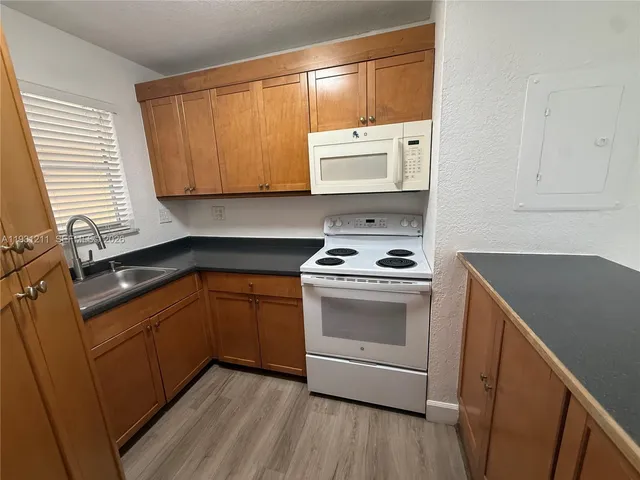 a kitchen with a sink stove and cabinets