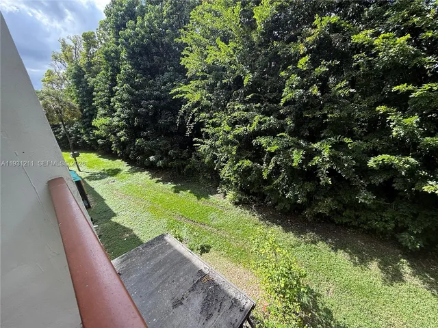 a view of a back yard from the balcony