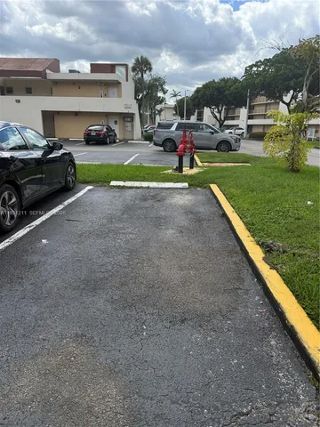a view of outdoor space with deck and car parked