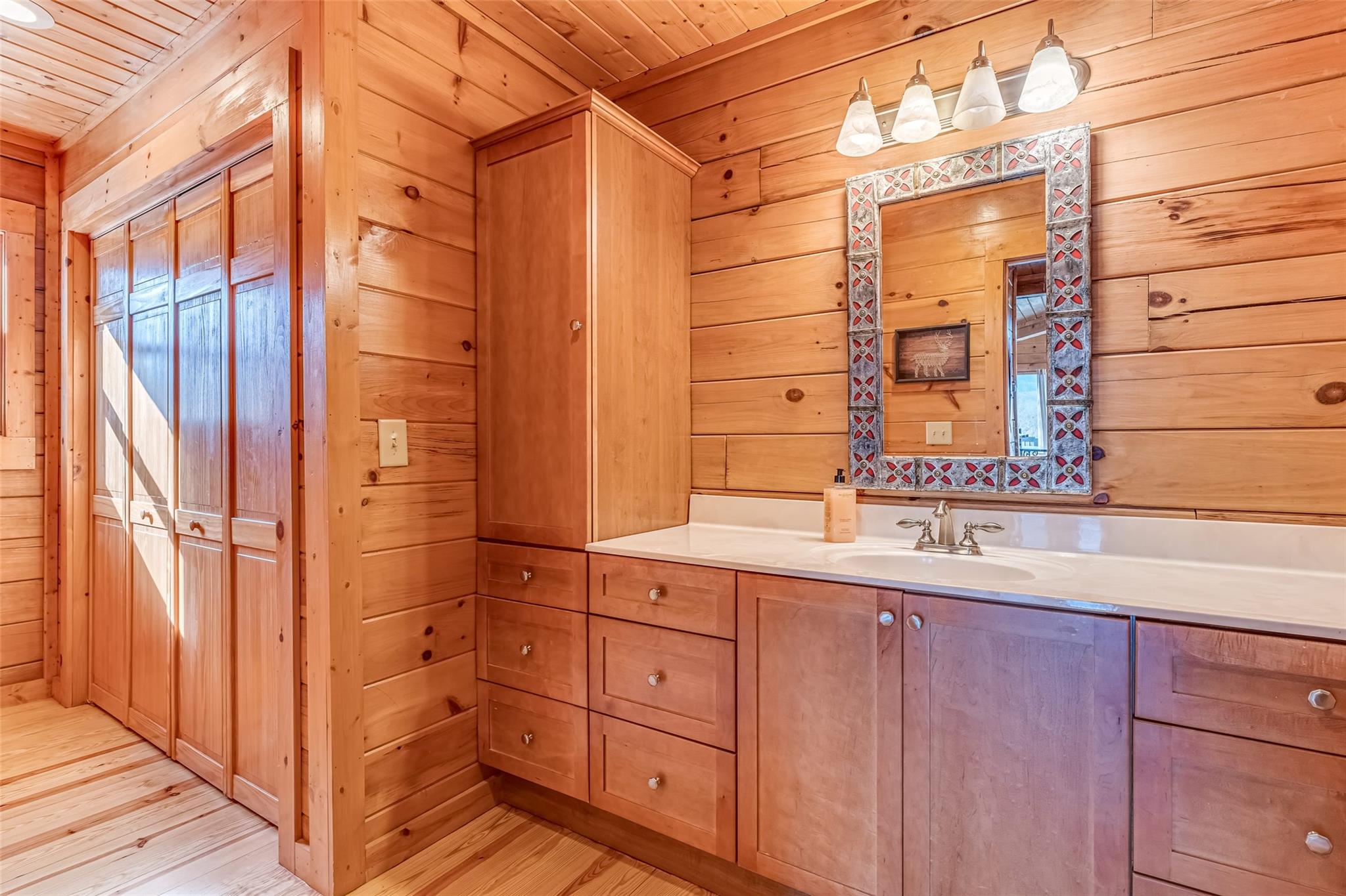 61 North Boundary Rd Mill Spring Mill Spring, NC 28756 - Photo 15 of 46 a bathroom with a double vanity sink and mirror