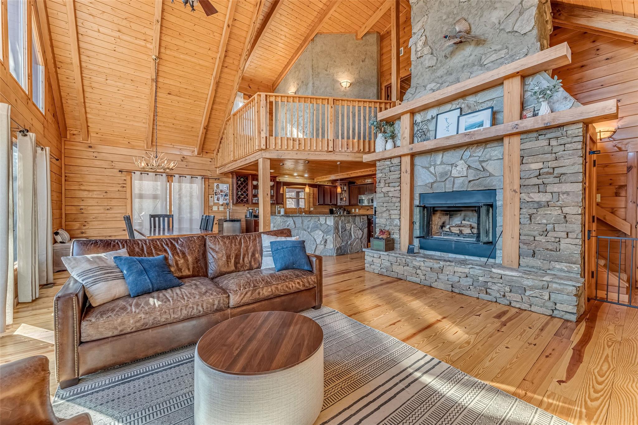 61 North Boundary Rd Mill Spring Mill Spring, NC 28756 - Photo 3 of 46 a living room with furniture a fireplace and a large window