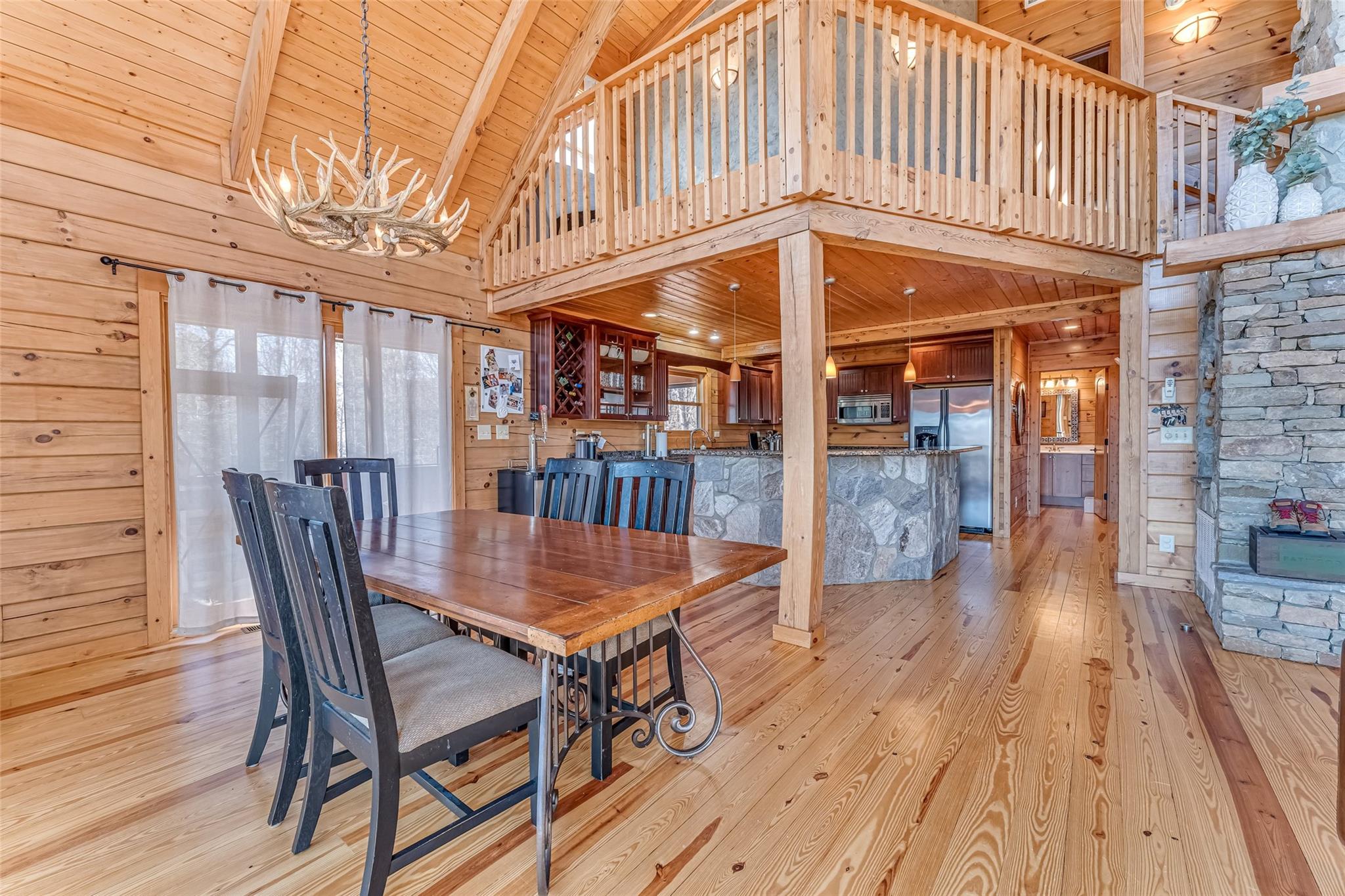 61 North Boundary Rd Mill Spring Mill Spring, NC 28756 - Photo 6 of 46 a view of a roof deck with table and chairs with wooden floor and fence