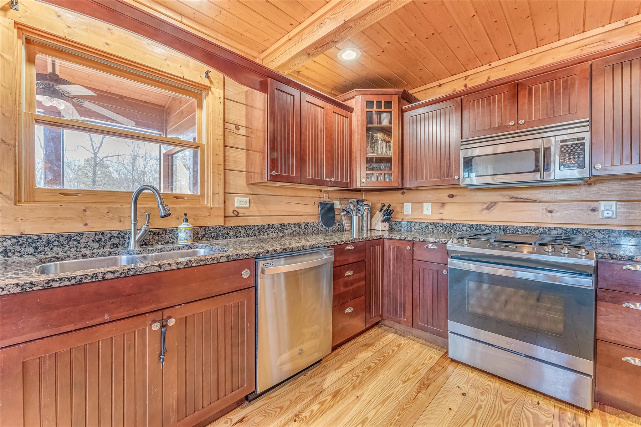 61 North Boundary Rd Mill Spring Mill Spring, NC 28756 - Photo 10 of 46 a kitchen with granite countertop a stove sink and cabinets