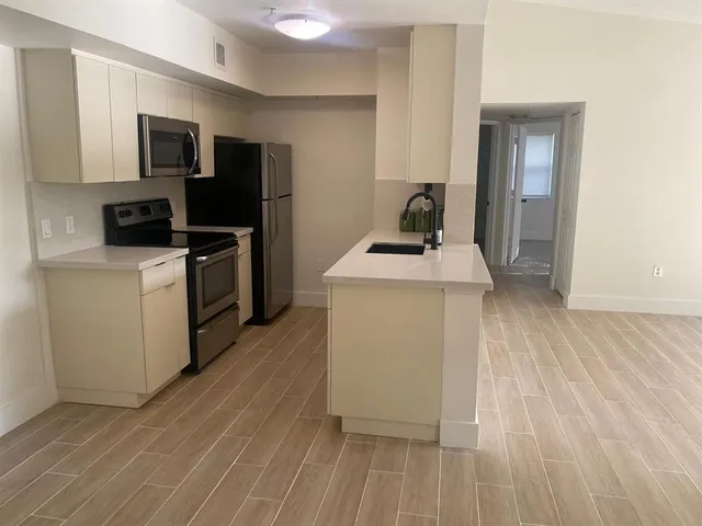 a kitchen that has a sink and a stove in it