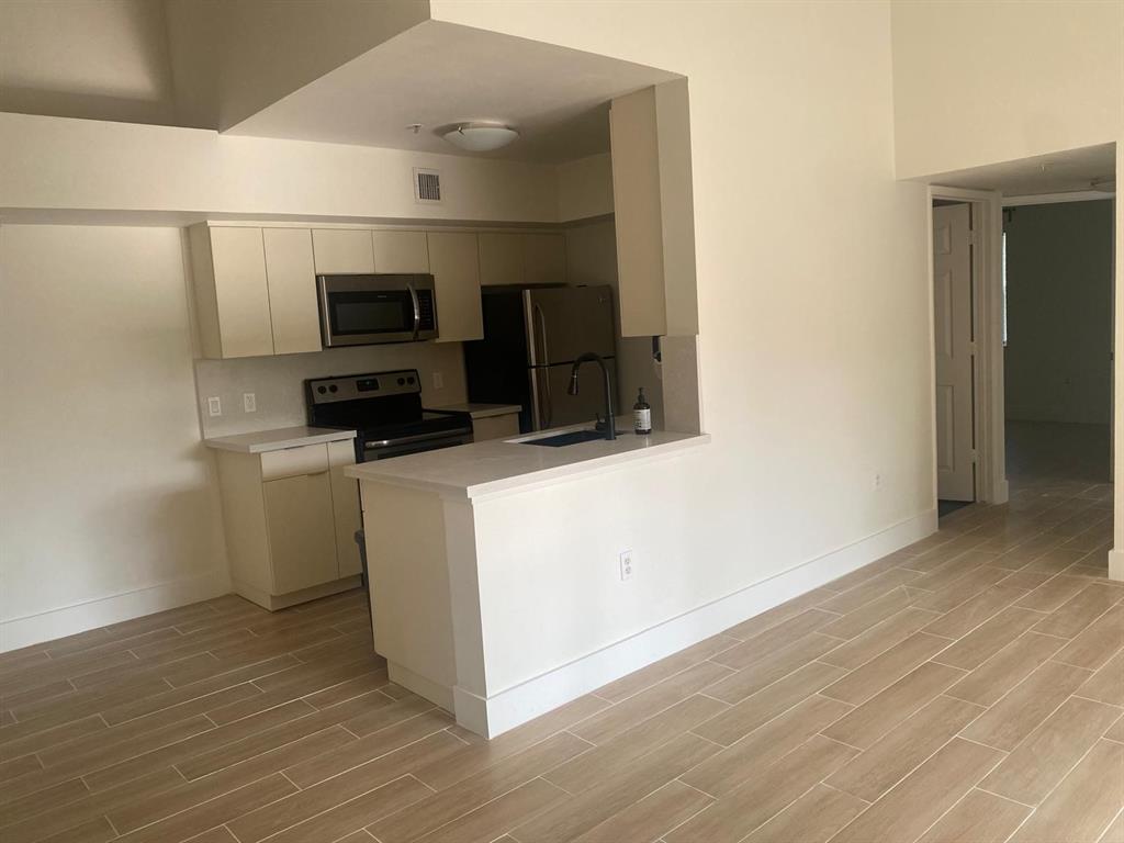 2457 Centergate Drive, Unit 302 Miramar, FL 33025 - Photo 4 of 10 a view of a kitchen with electric appliances
