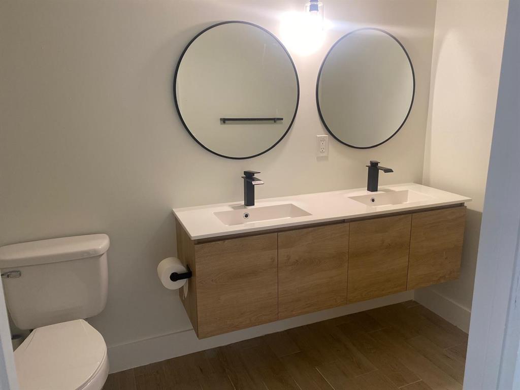 2457 Centergate Drive, Unit 302 Miramar, FL 33025 - Photo 5 of 10 a bathroom with a toilet a sink and a mirror