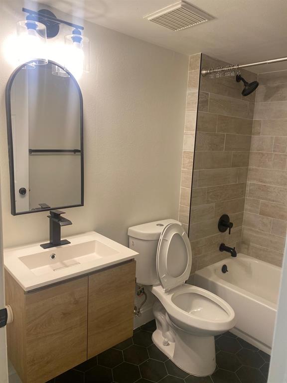 2457 Centergate Drive, Unit 302 Miramar, FL 33025 - Photo 8 of 10 a bathroom with a toilet sink and mirror