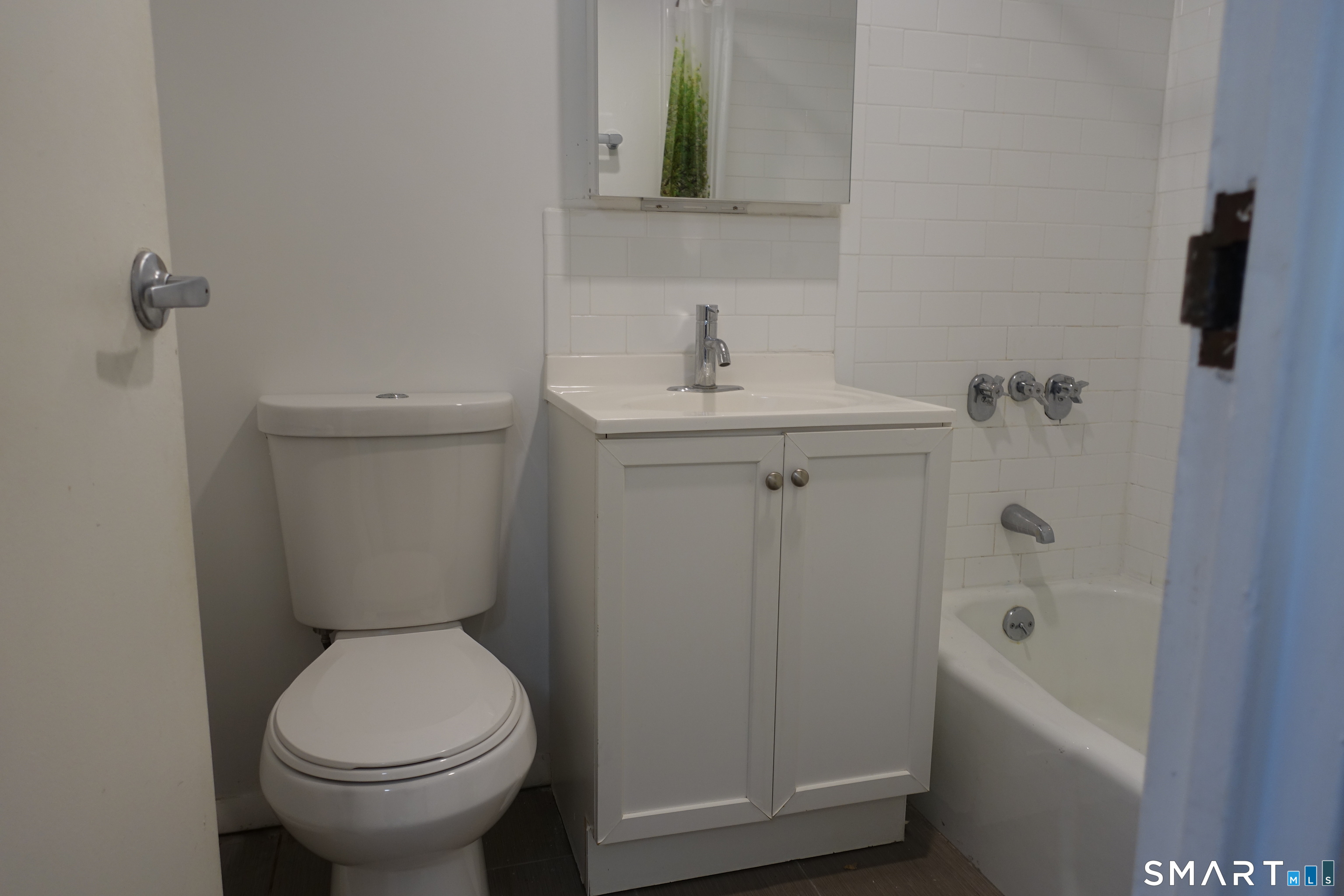 87 Glenbrook Road, Unit 6E Stamford, CT 06902 - Photo 15 of 23 a bathroom with a sink a toilet and shower