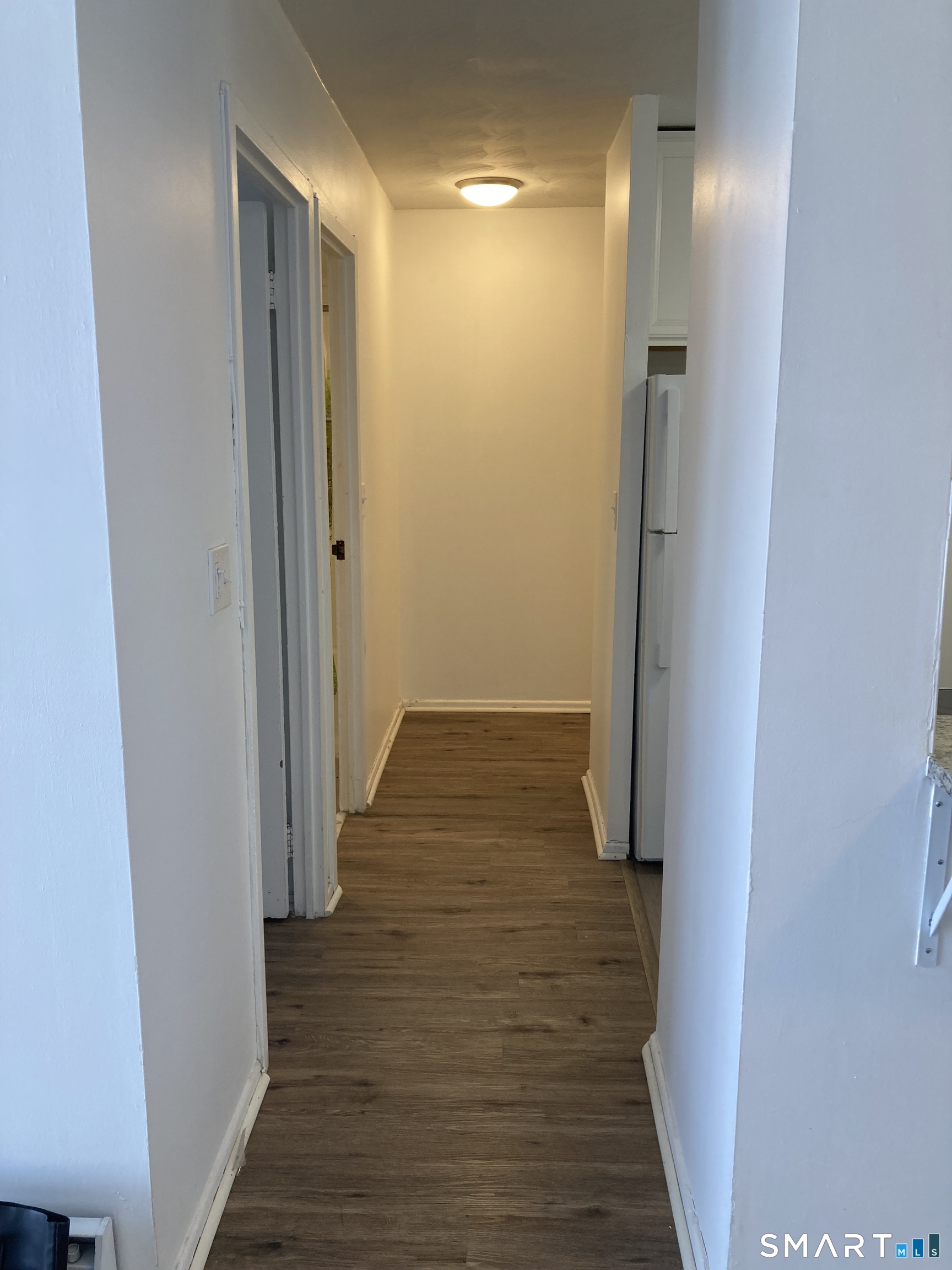 87 Glenbrook Road, Unit 6E Stamford, CT 06902 - Photo 16 of 23 a view of a hallway with wooden floor