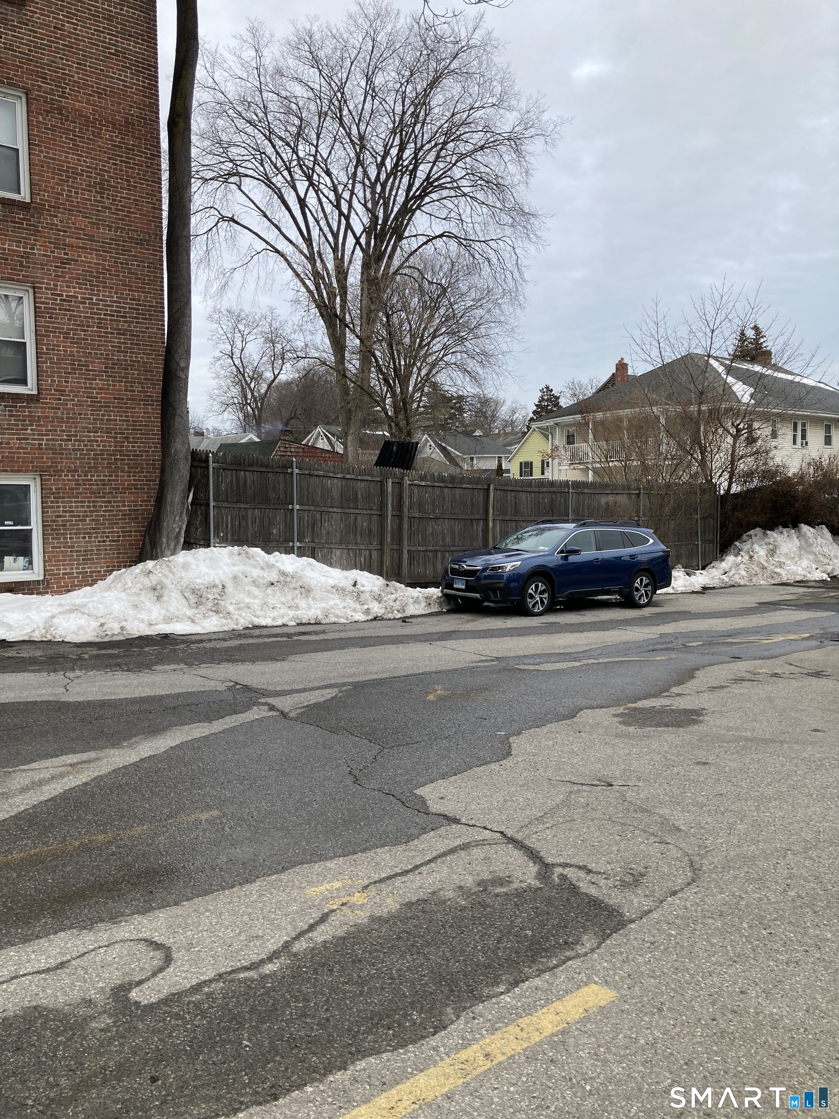 87 Glenbrook Road, Unit 6E Stamford, CT 06902 - Photo 19 of 23 a car parked on the side of the road