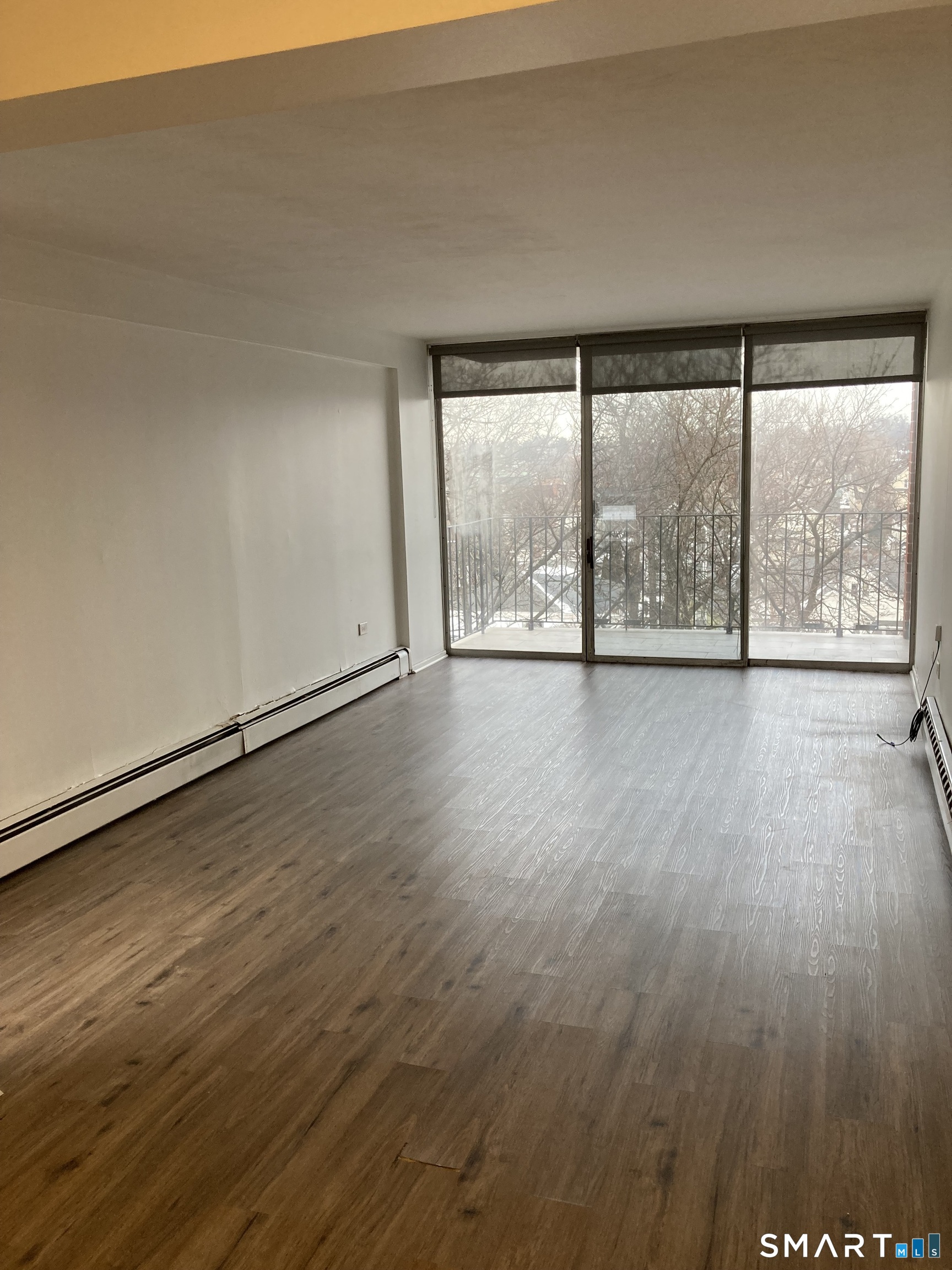 87 Glenbrook Road, Unit 6E Stamford, CT 06902 - Photo 22 of 23 wooden floor in an empty room with a window
