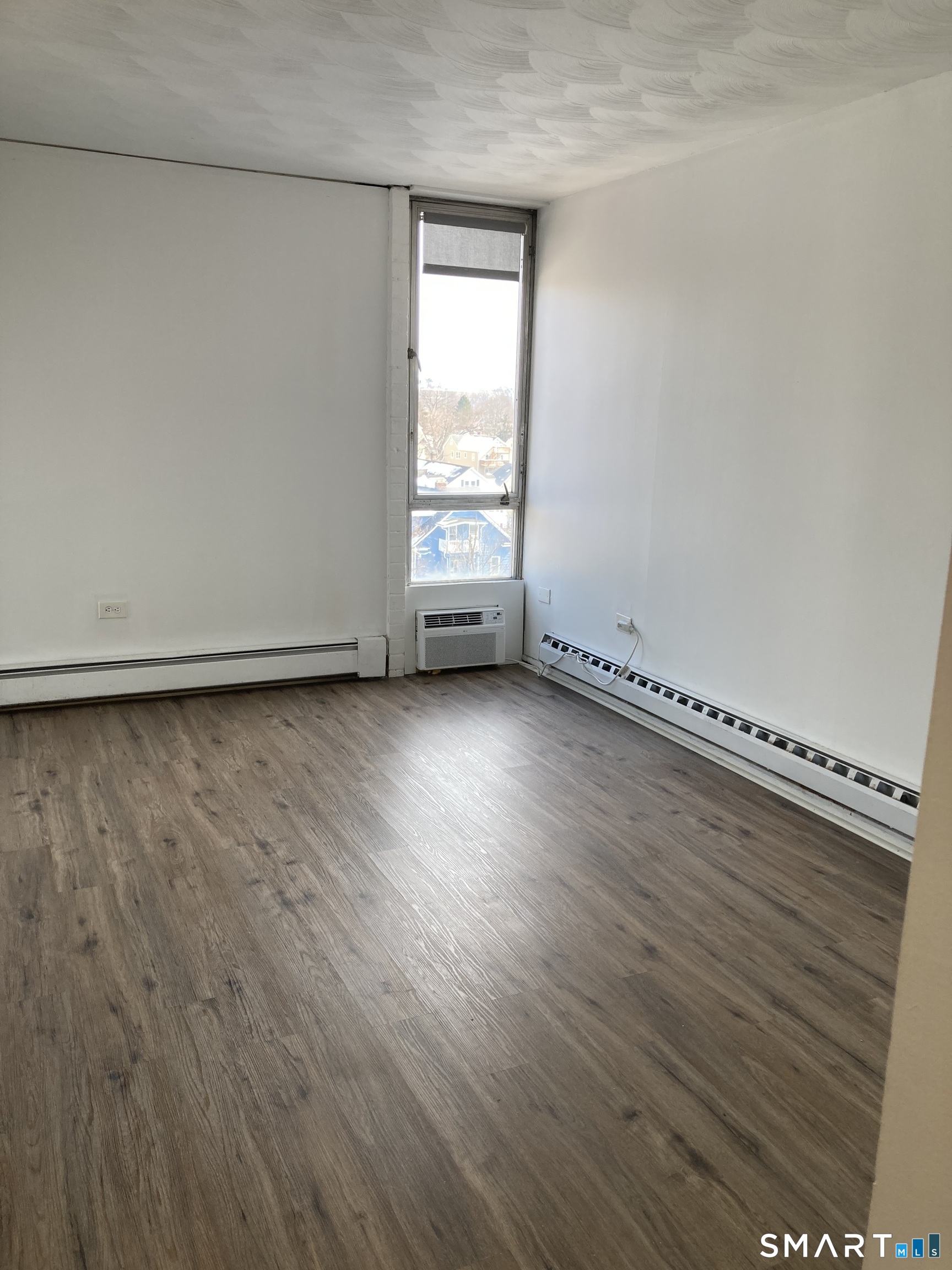 87 Glenbrook Road, Unit 6E Stamford, CT 06902 - Photo 8 of 23 a view of a room with wooden floor and window