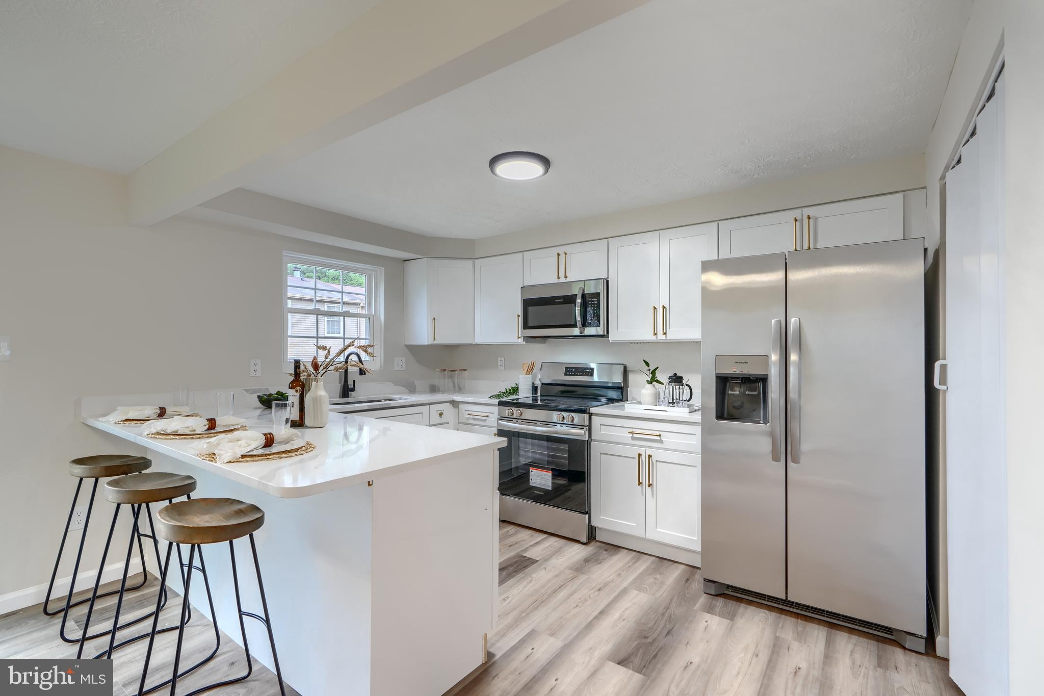 4008 Rustico Road Baltimore, MD 21220 - Photo 12 of 37 a kitchen with a sink appliances cabinets and counter space