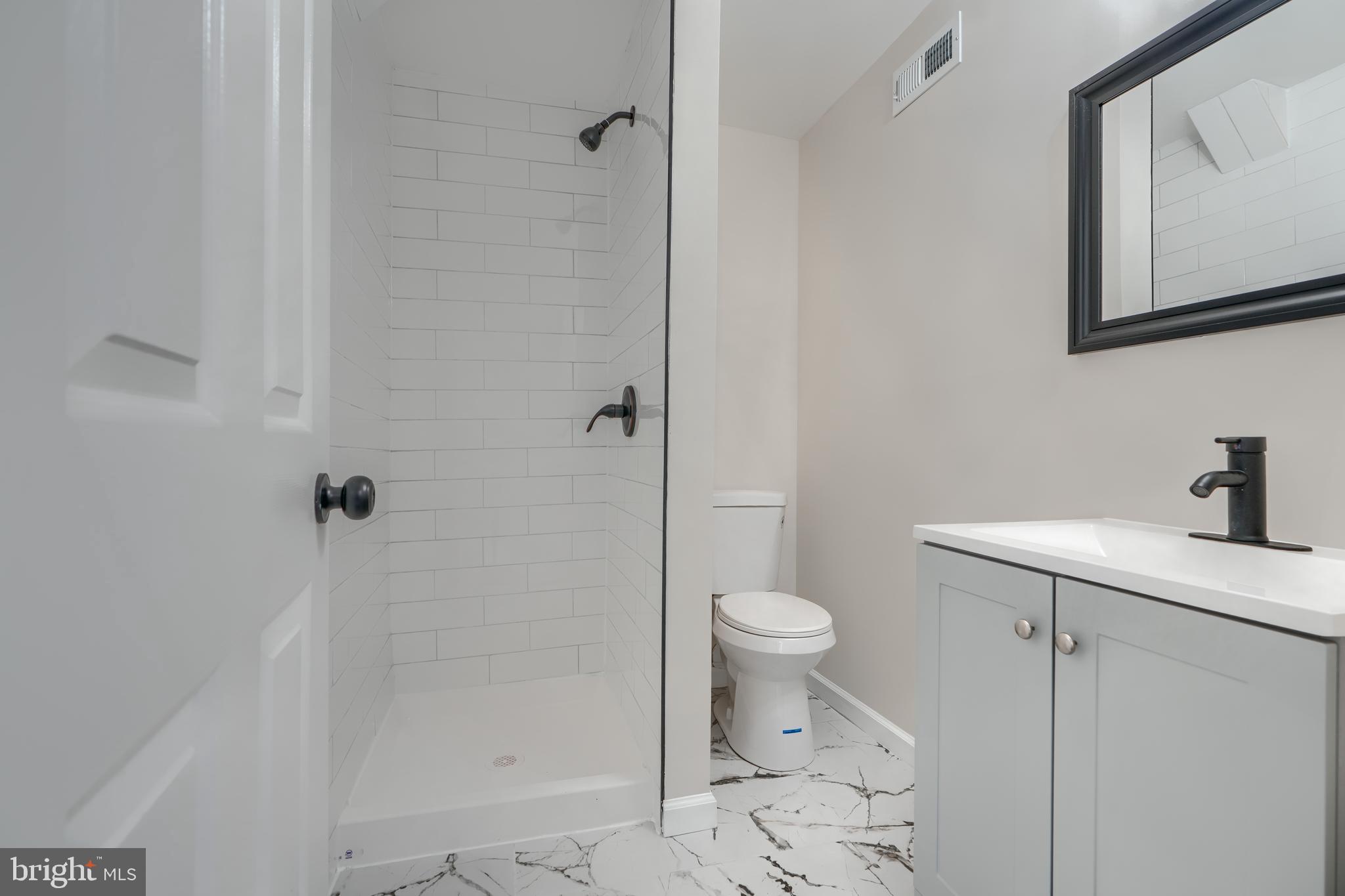 4008 Rustico Road Baltimore, MD 21220 - Photo 30 of 37 a bathroom with a toilet a sink and shower