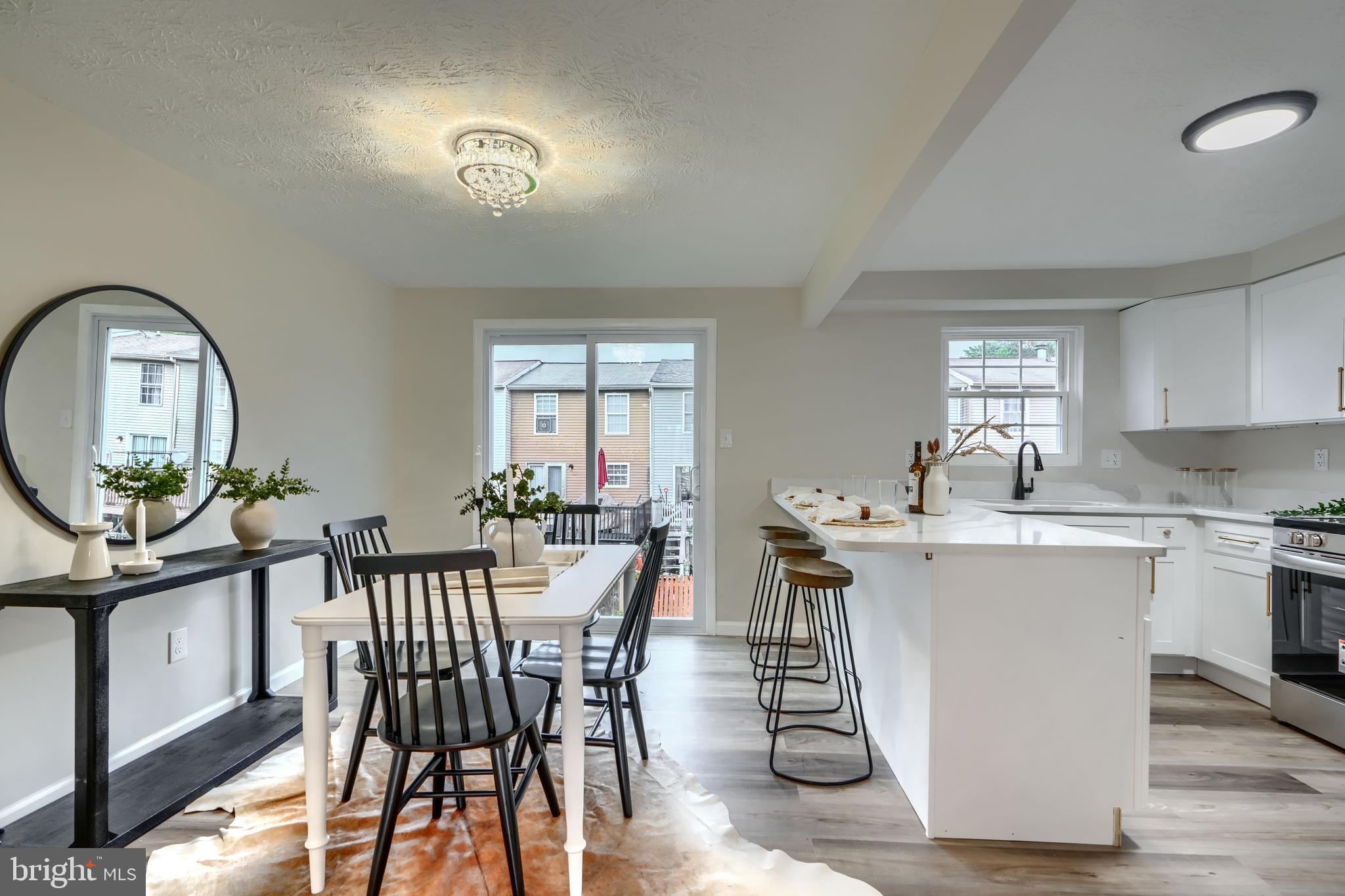4008 Rustico Road Baltimore, MD 21220 - Photo 34 of 37 a view of a dining room with furniture window and wooden floor
