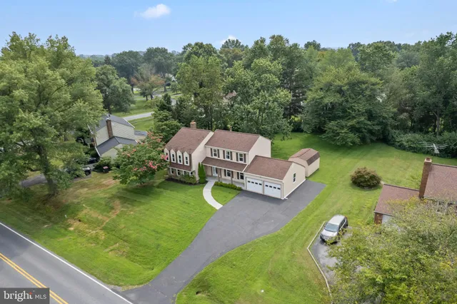 an aerial view of a house with outdoor space swimming pool