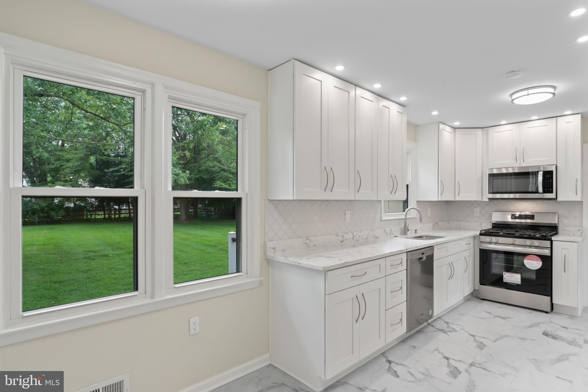 17004 Cashell Road Rockville, MD 20853 - Photo 14 of 80 a kitchen with a sink stove top oven and cabinets