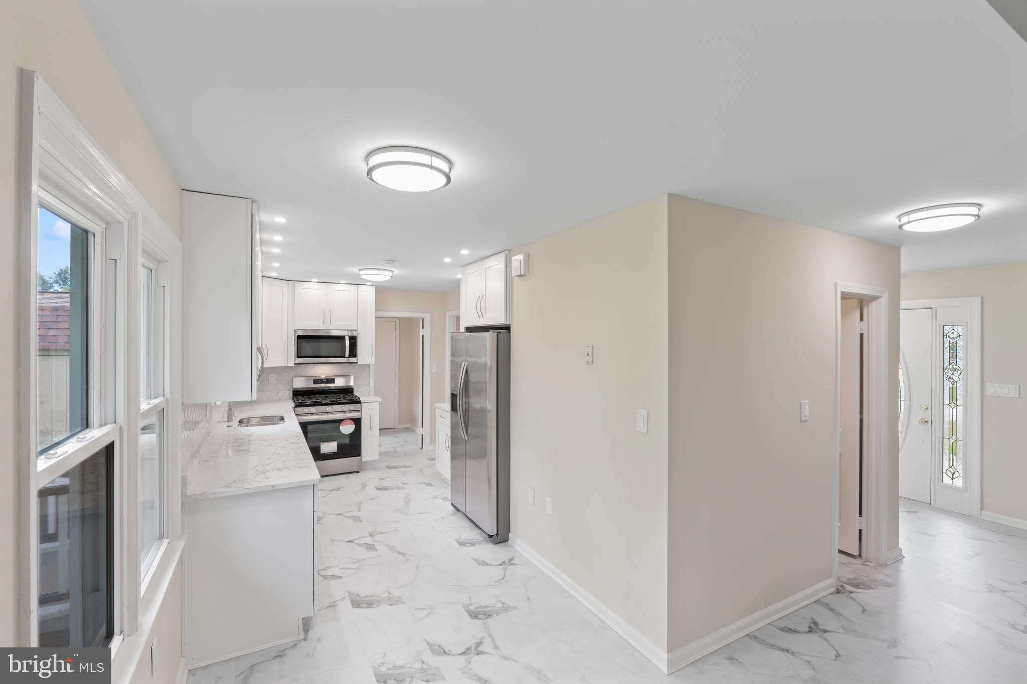 17004 Cashell Road Rockville, MD 20853 - Photo 18 of 80 a kitchen with stainless steel appliances a refrigerator and a stove top oven