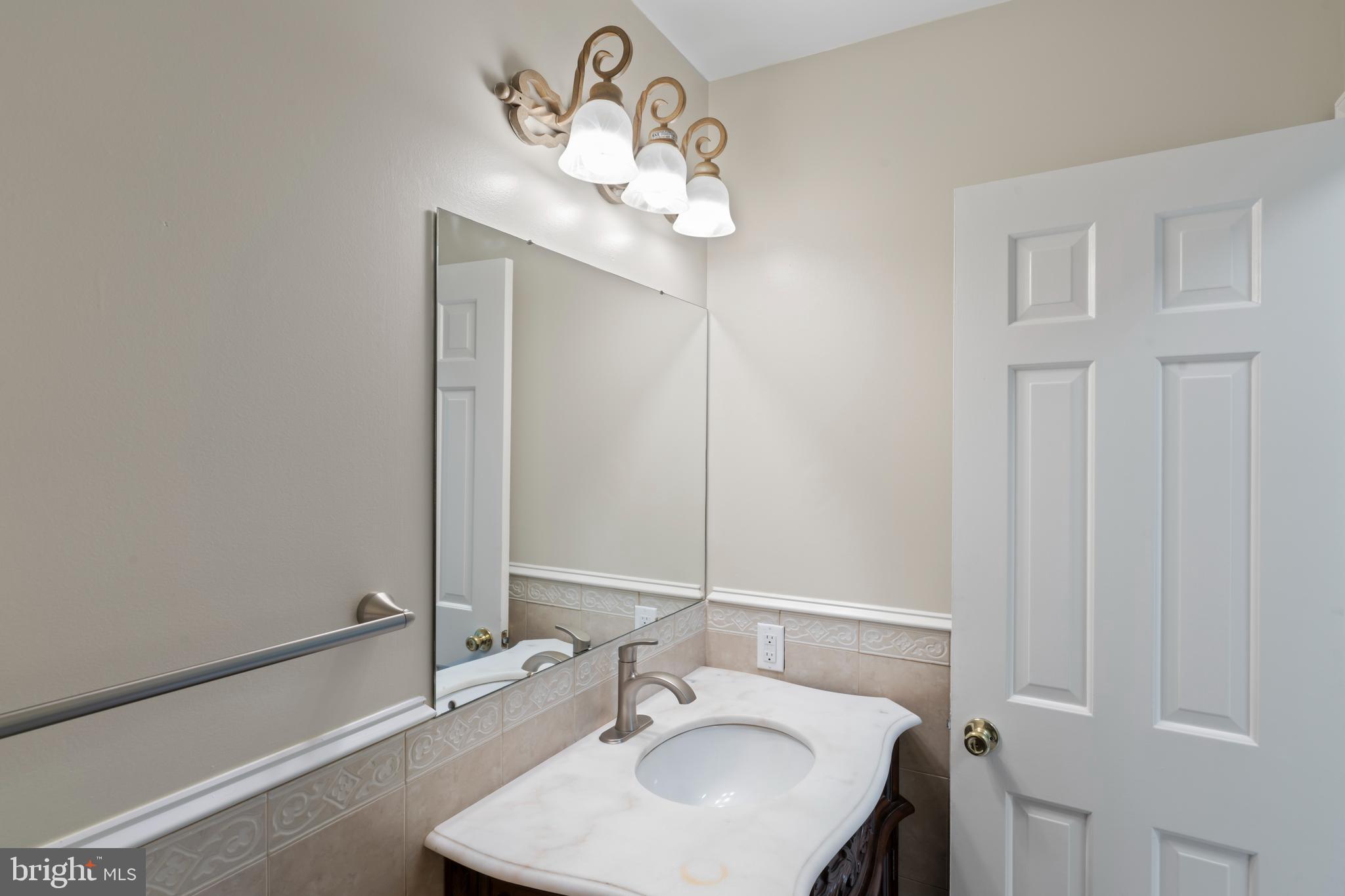 17004 Cashell Road Rockville, MD 20853 - Photo 20 of 80 a bathroom with a sink and a mirror