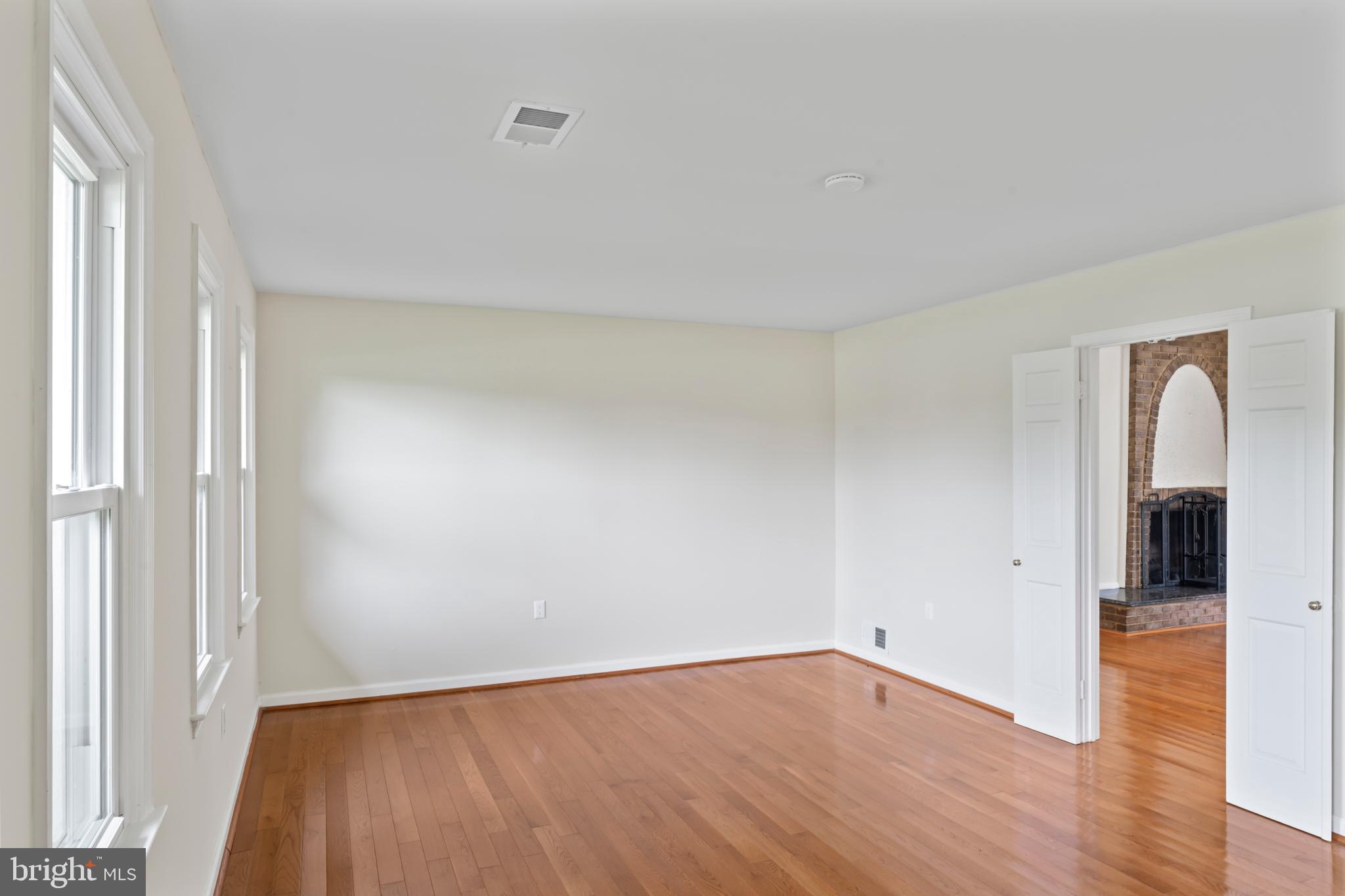17004 Cashell Road Rockville, MD 20853 - Photo 29 of 80 an empty room with wooden floor and windows