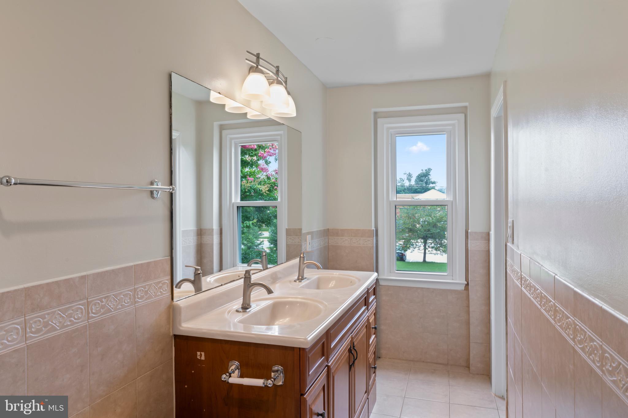 17004 Cashell Road Rockville, MD 20853 - Photo 38 of 80 a bathroom with a sink a vanity and a large mirror