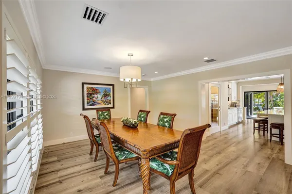 a view of a dining room with furniture and wooden floor