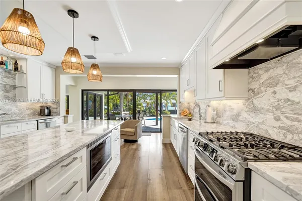 a kitchen with stainless steel appliances granite countertop a stove and a sink