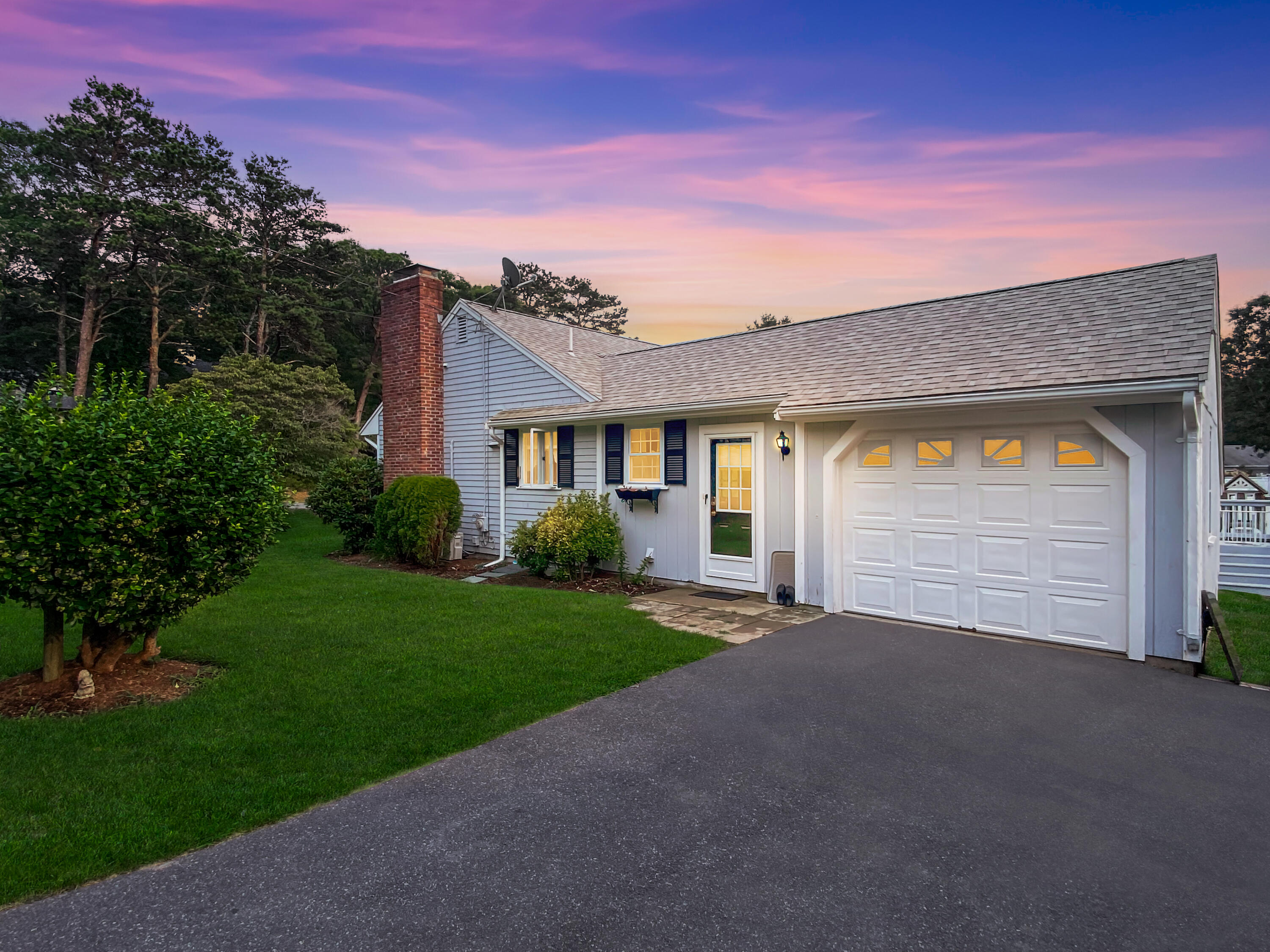 29 Padlock Lane Centerville, MA 02632 - Photo 2 of 33 a front view of a house with a yard and garage