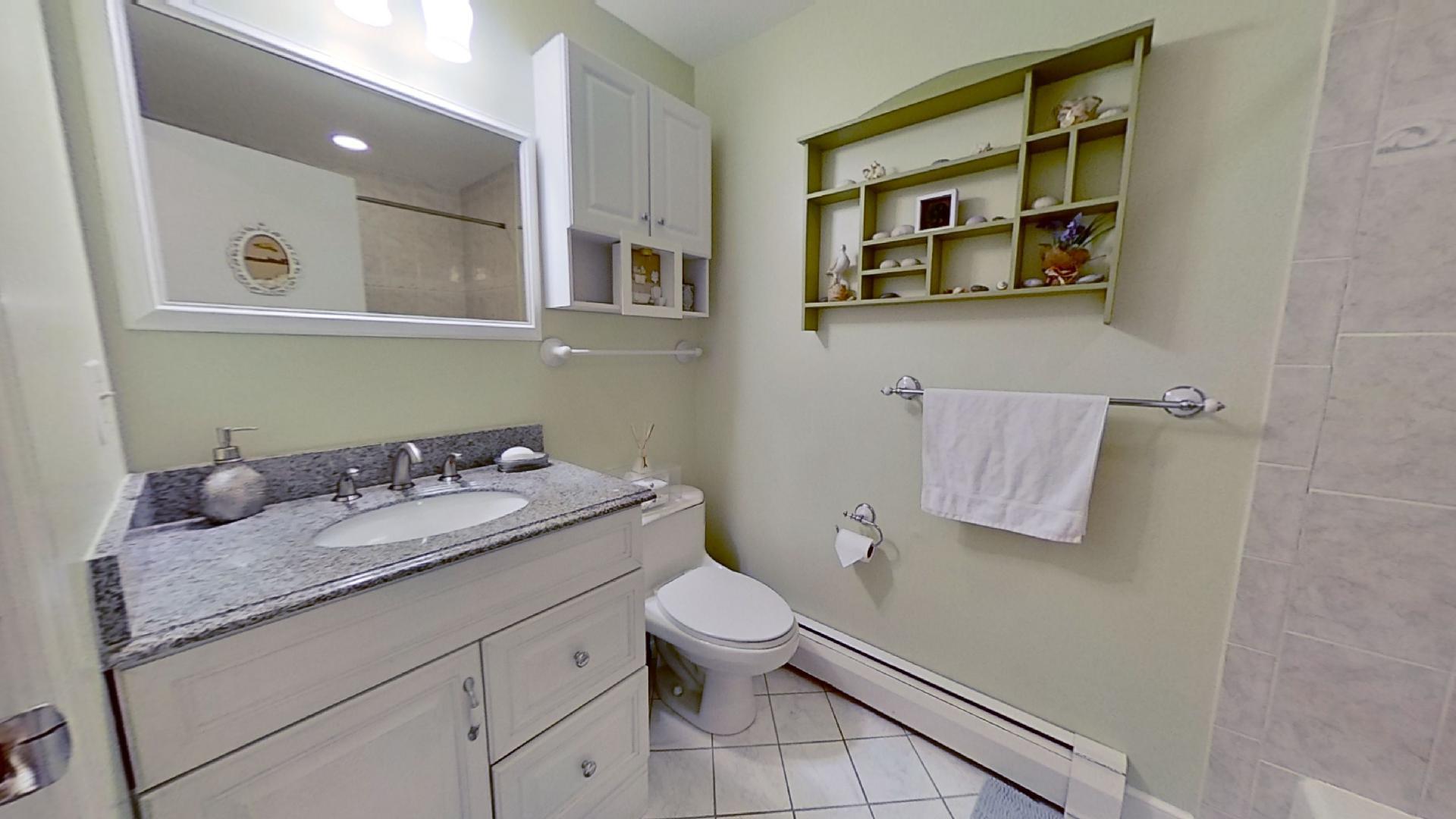 29 Padlock Lane Centerville, MA 02632 - Photo 22 of 33 a bathroom with a granite countertop sink and a mirror