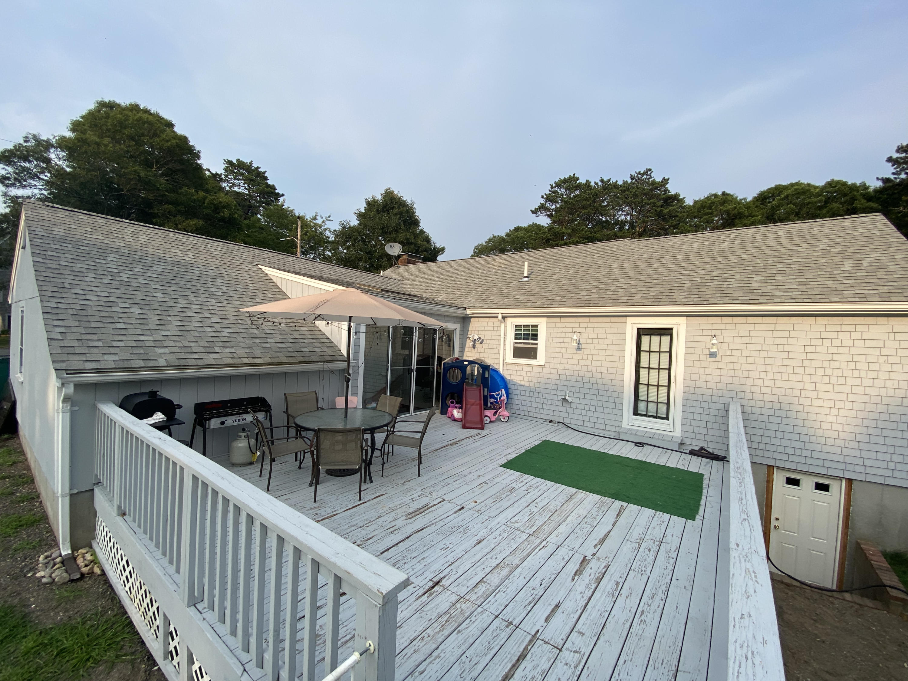 29 Padlock Lane Centerville, MA 02632 - Photo 26 of 33 a view of a patio with table and chairs with wooden floor and fence
