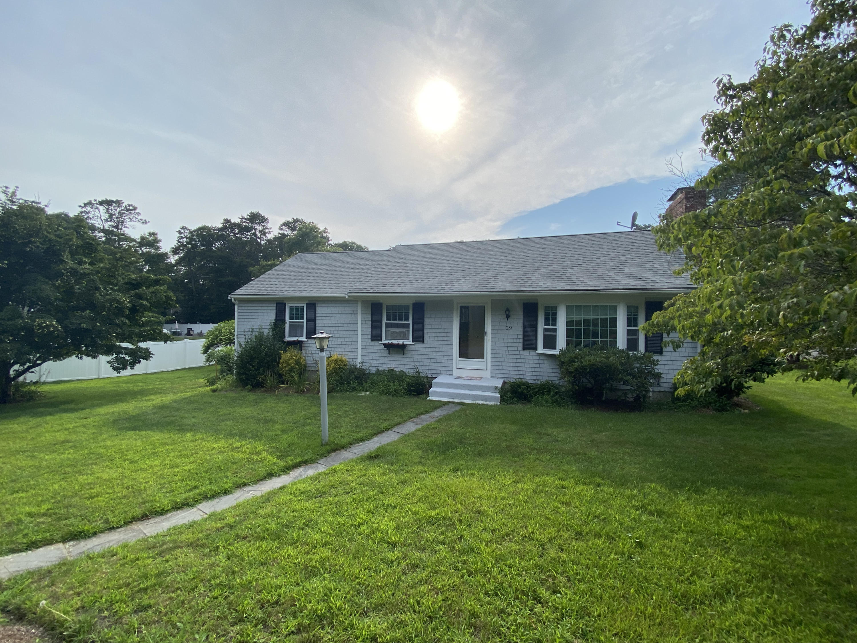 29 Padlock Lane Centerville, MA 02632 - Photo 31 of 33 a front view of a house with a yard and trees
