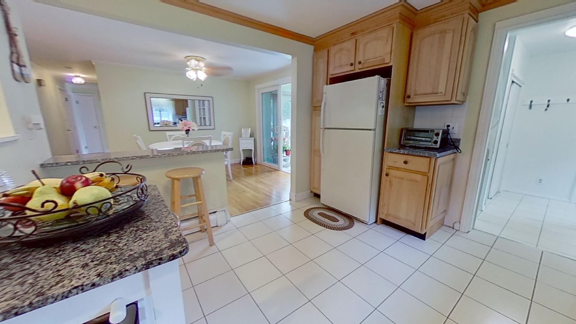 29 Padlock Lane Centerville, MA 02632 - Photo 9 of 33 a kitchen with stainless steel appliances granite countertop a refrigerator a sink a stove a dining table and chairs