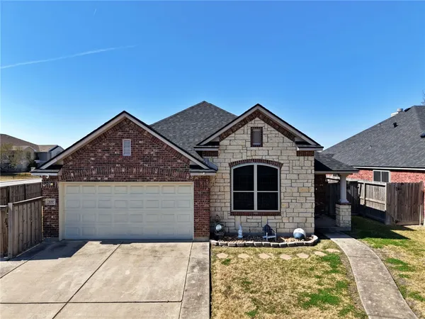 a front view of a house with yard