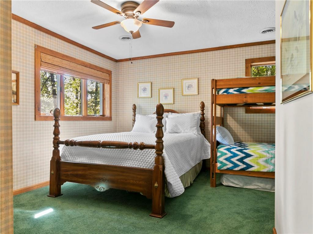 1641 Concord Church Road Roxboro, NC 27574 - Photo 30 of 30 a bedroom with a bed and a chandelier