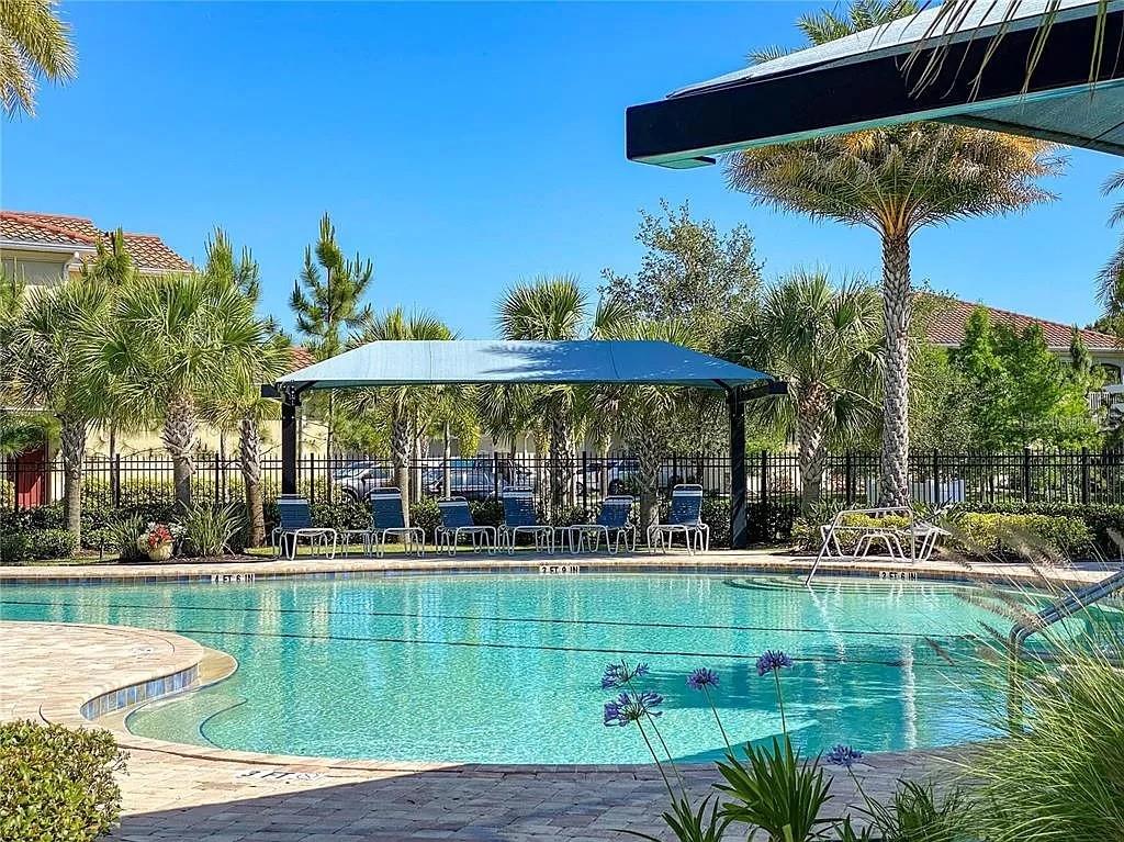 8220 Enclave Way, Unit 101 Sarasota, FL 34243 - Photo 5 of 8 front view of a house with a yard