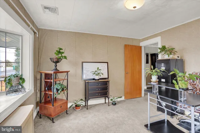 a view of a workspace with furniture and a potted plant