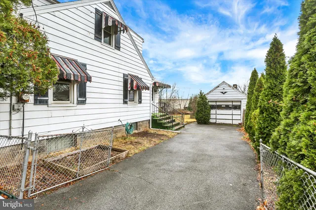 a view of a house with backyard porch and sitting area