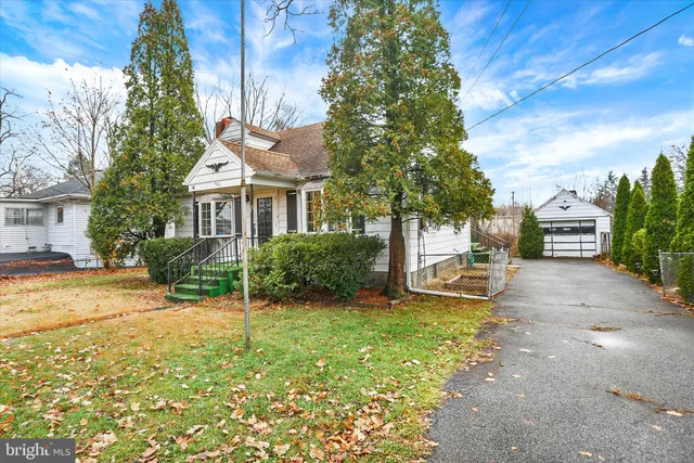 a view of a house with backyard sitting area and garden